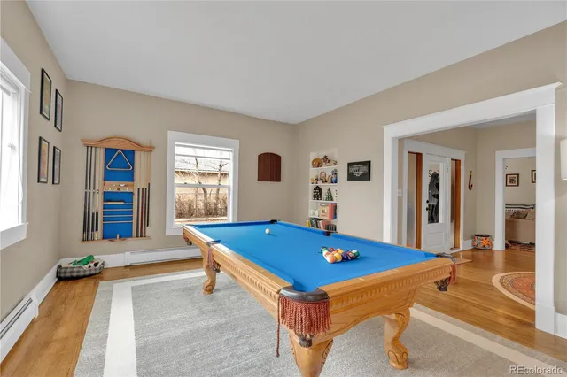 a room with pool table and windows