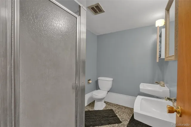 a front view of house with yard and trees in the background