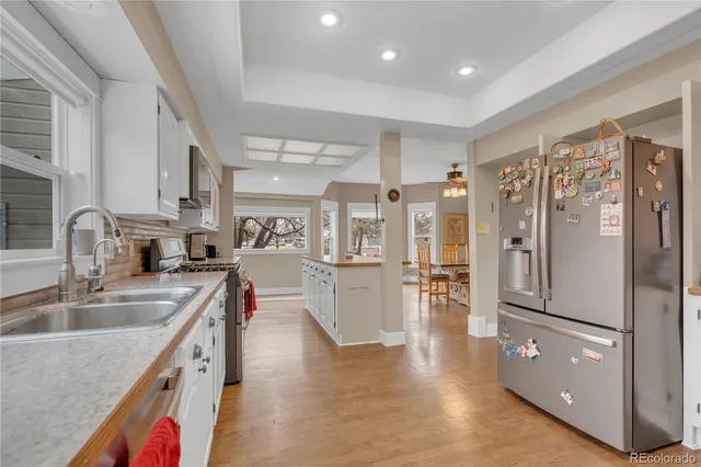 a kitchen with stainless steel appliances granite countertop a refrigerator and a sink