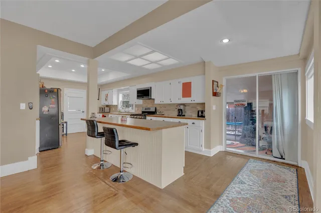 a kitchen with refrigerator and cabinets