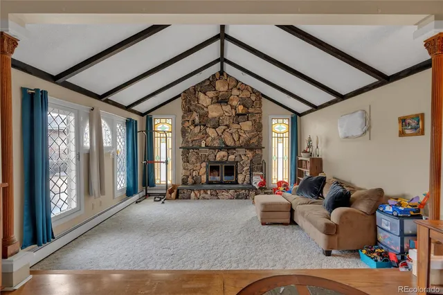 a living room with furniture large window and a fireplace