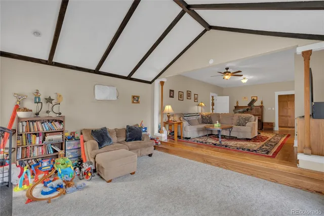 a living room with furniture and a book shelf