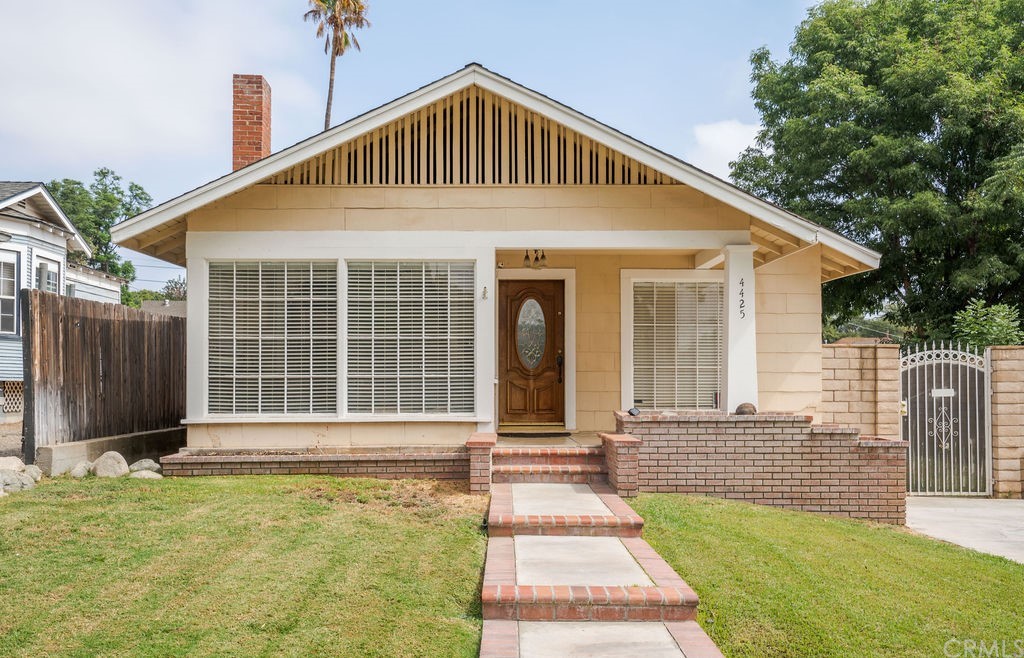 4425 11th Street Riverside, CA 92501 - Photo 1 of 1 a front view of a house with a yard