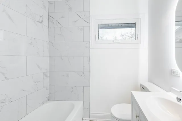 a bathroom with a toilet a sink and bathtub