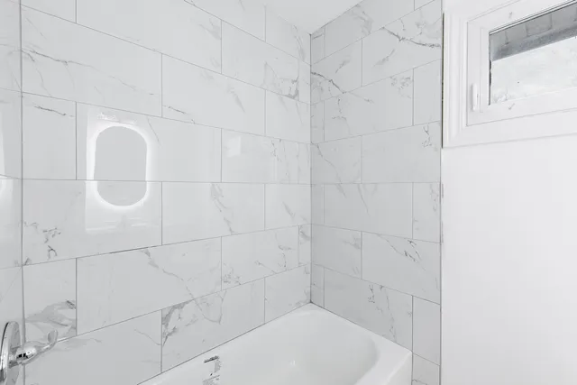 a bathroom with a white bathtub