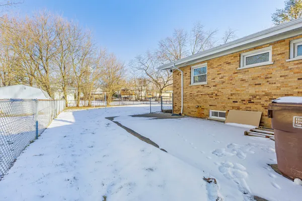 a view of a backyard with wooden fence