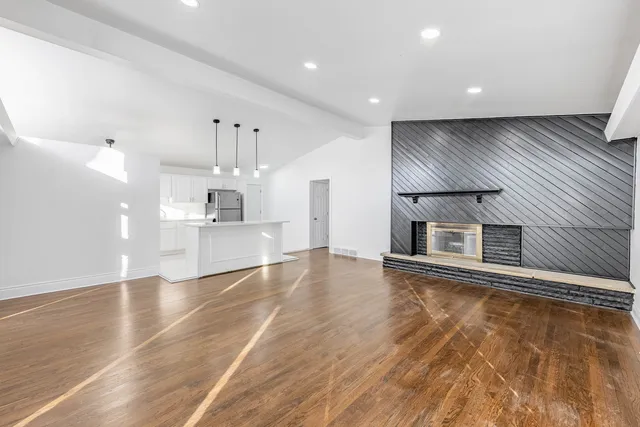 a view of a kitchen with a sink and wooden floor