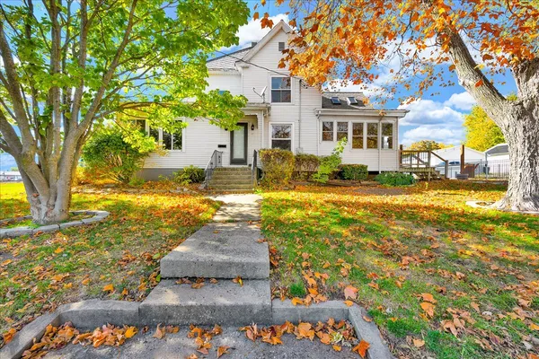 a view of a house with a yard and tree s