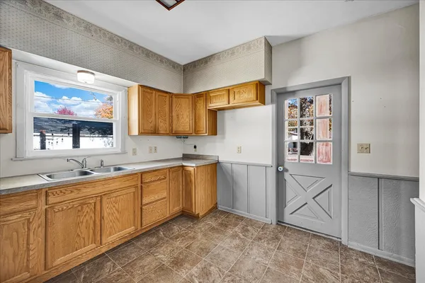 a kitchen with granite countertop a refrigerator and a sink