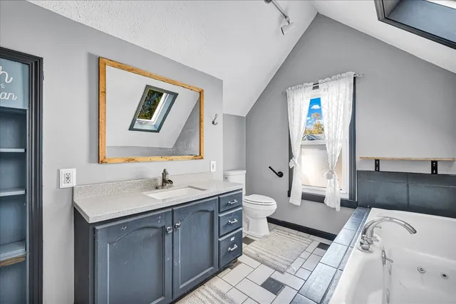 a view of a livingroom with a ceiling fan and window