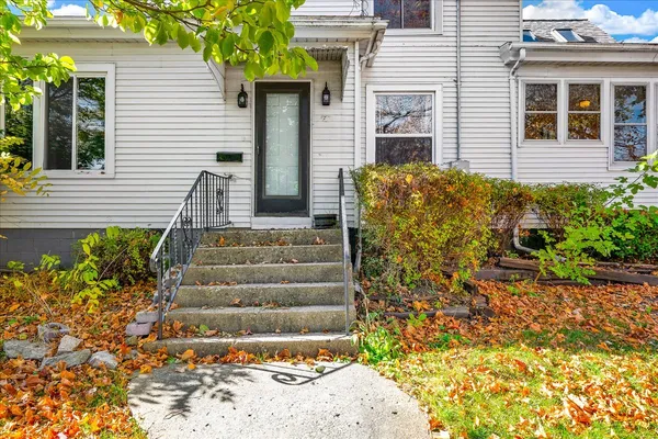 a view of a house with potted plants