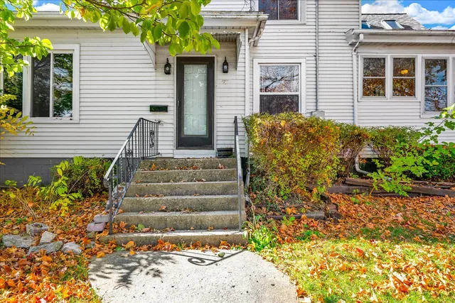 a view of a house with potted plants