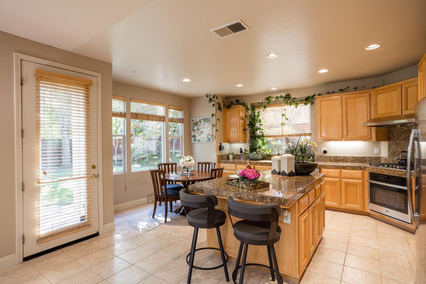 52 Foster Drive San Ramon, CA 94583 - Photo 17 of 50 a kitchen with a dining table chairs and white appliances