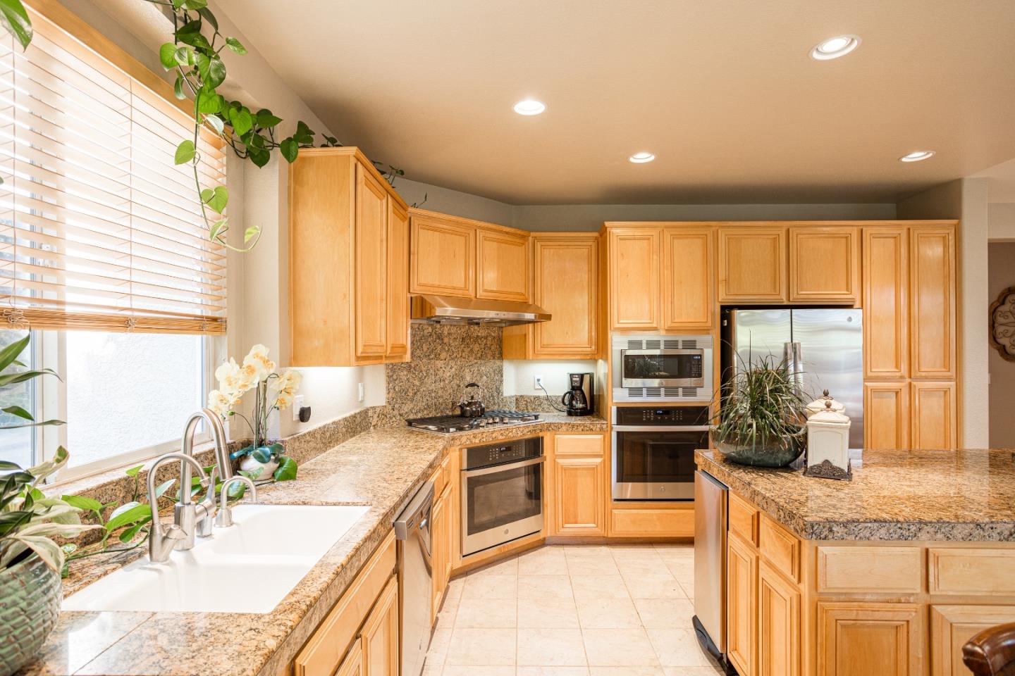 52 Foster Drive San Ramon, CA 94583 - Photo 20 of 50 a large kitchen with kitchen island granite countertop a large window and stainless steel appliances