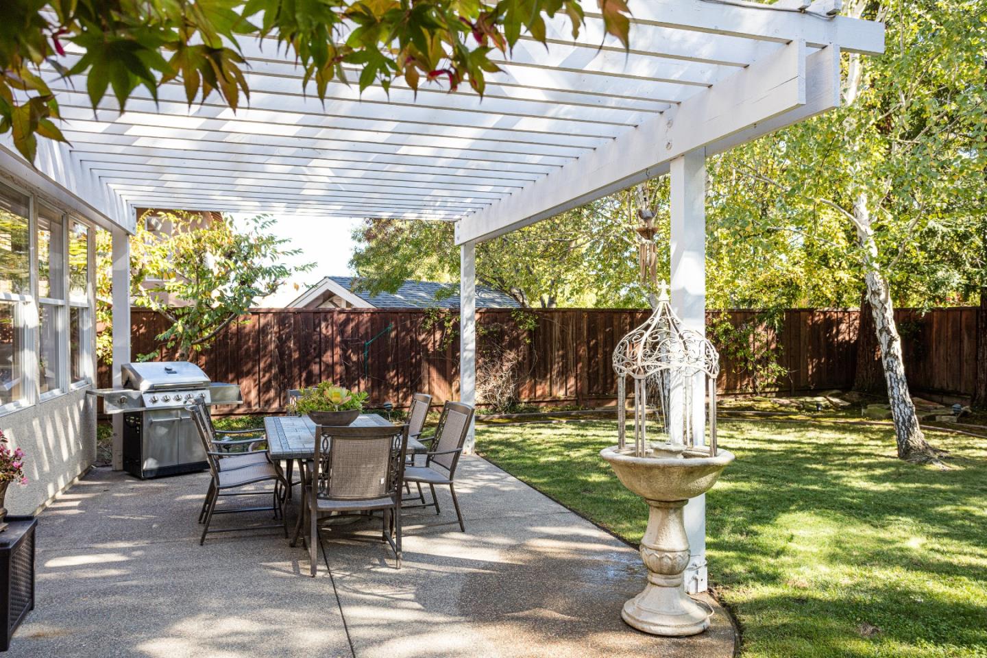 52 Foster Drive San Ramon, CA 94583 - Photo 33 of 50 a view of a patio with table and chairs potted plants and palm trees