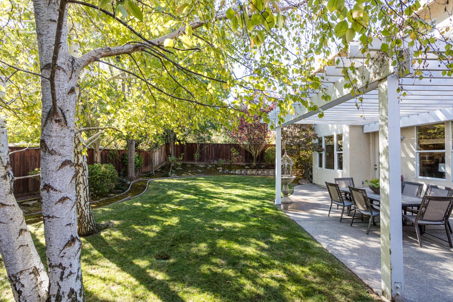 52 Foster Drive San Ramon, CA 94583 - Photo 34 of 50 a view of a backyard with table and chairs potted plants and a large tree