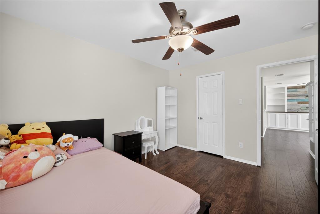 9633 Anns Way Plano, TX 75025 - Photo 28 of 37 a bedroom with a bed and wooden floor