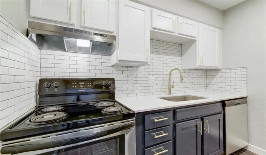 a kitchen with stainless steel appliances a stove and a sink