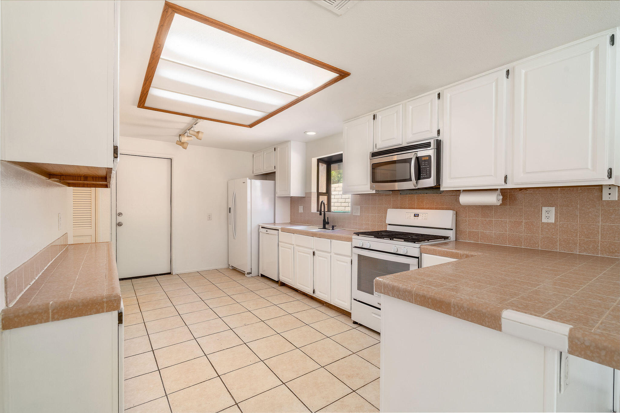 68750 Fortuna Road Cathedral City, CA 92234 - Photo 16 of 42 a kitchen with stainless steel appliances granite countertop a stove a sink and a microwave