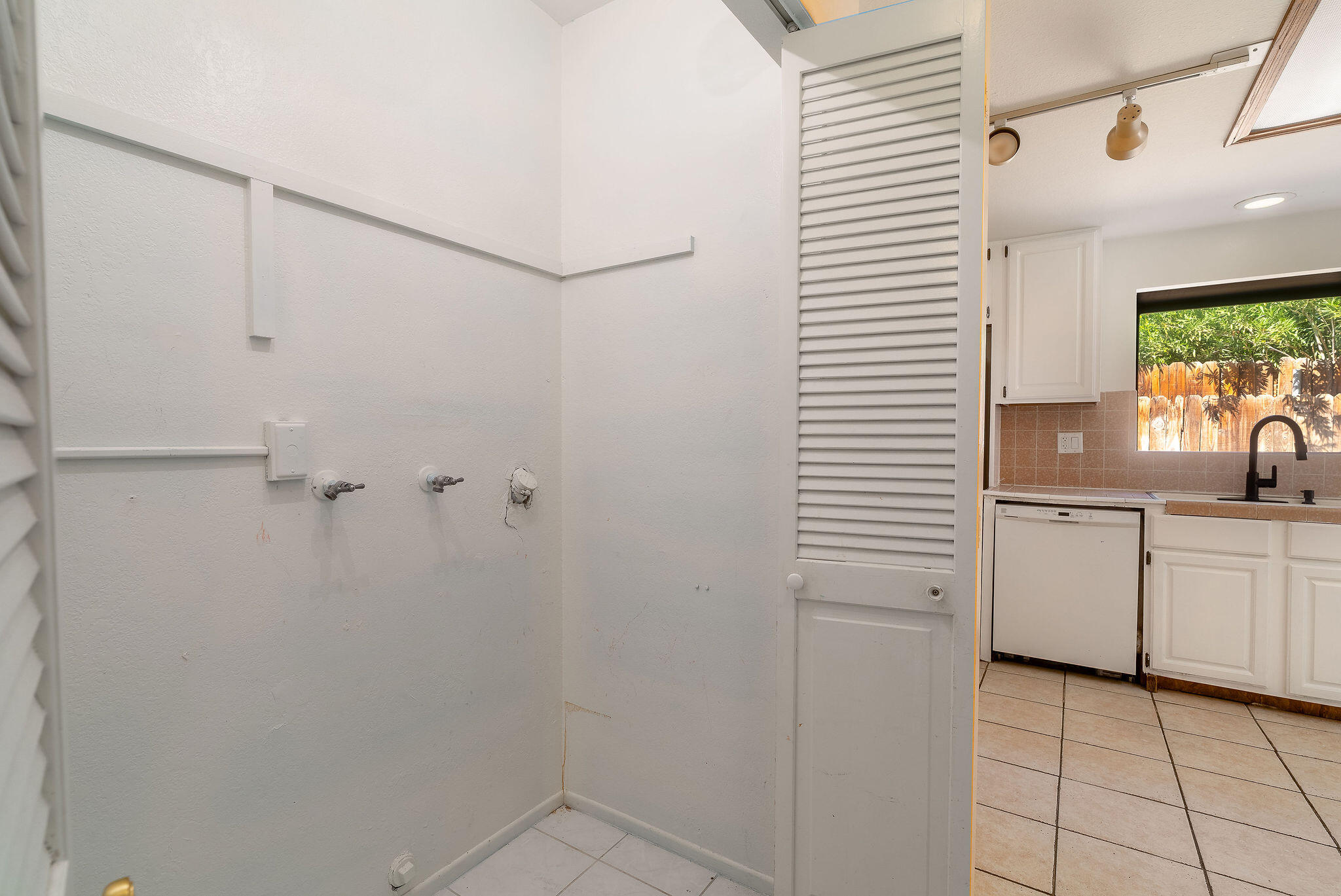 68750 Fortuna Road Cathedral City, CA 92234 - Photo 17 of 42 a view of a kitchen with white cabinets and white appliances
