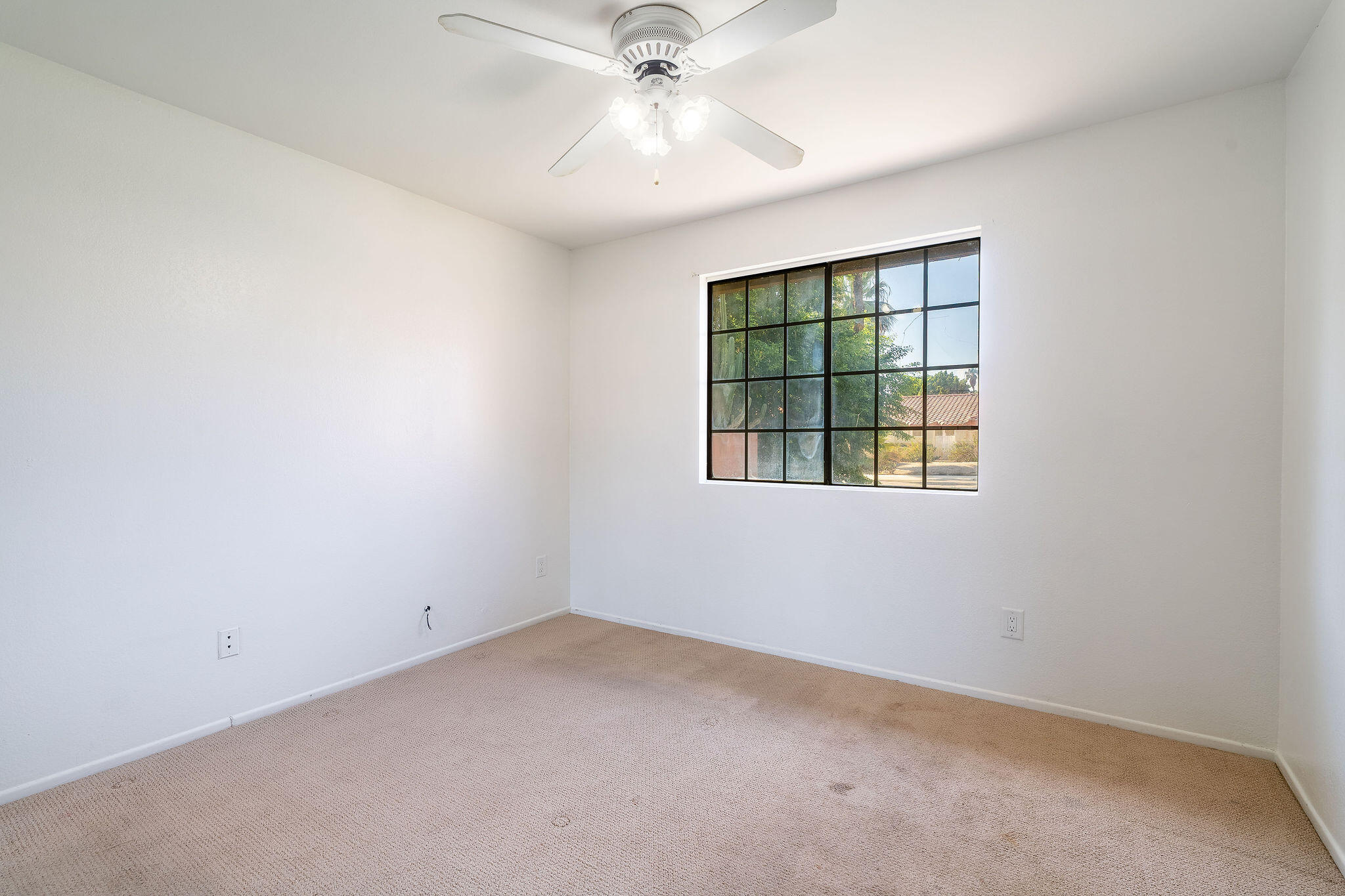 68750 Fortuna Road Cathedral City, CA 92234 - Photo 21 of 42 an empty room with a window and a ceiling fan