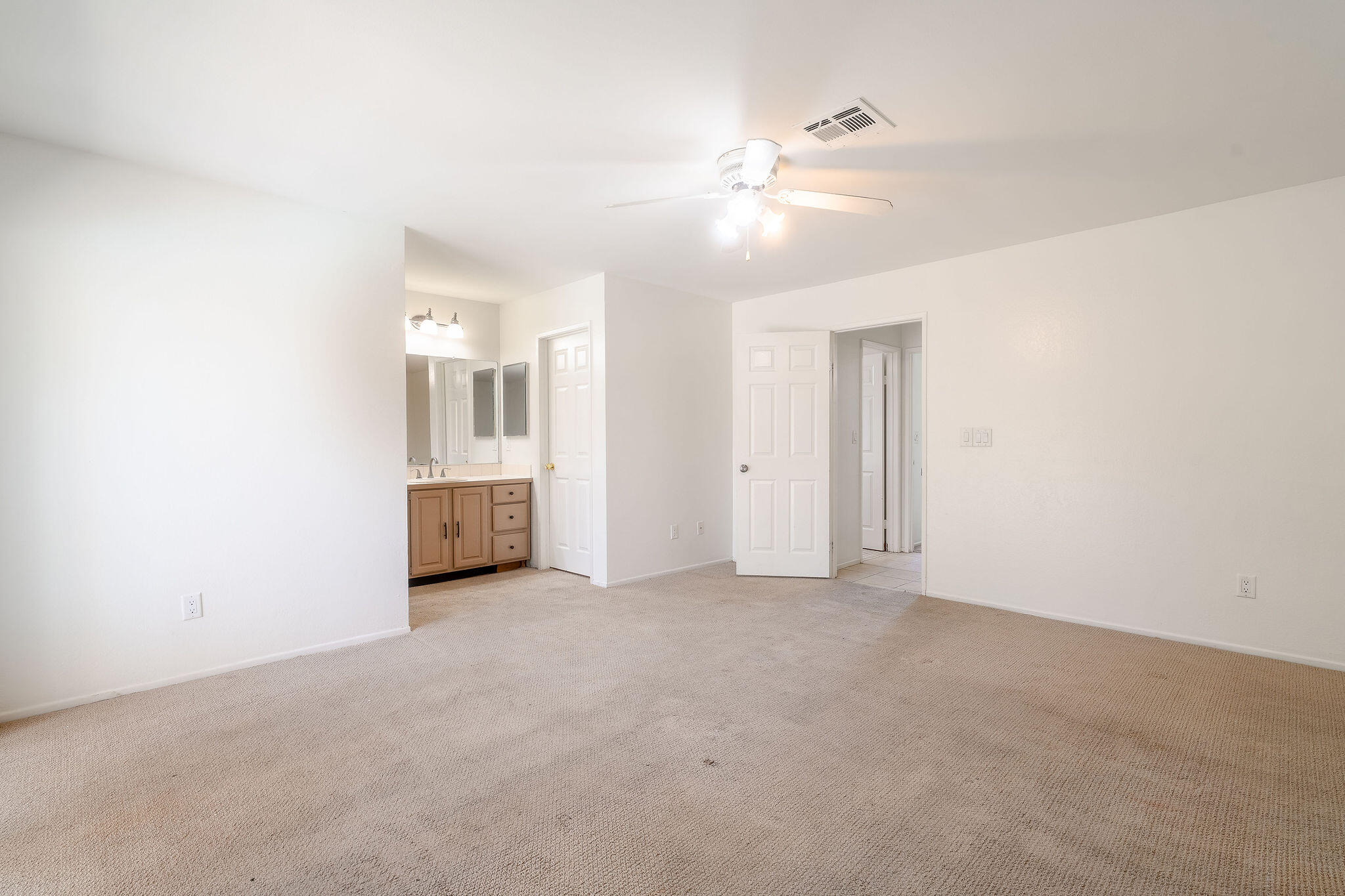 68750 Fortuna Road Cathedral City, CA 92234 - Photo 26 of 42 an empty room with chandelier fan and windows