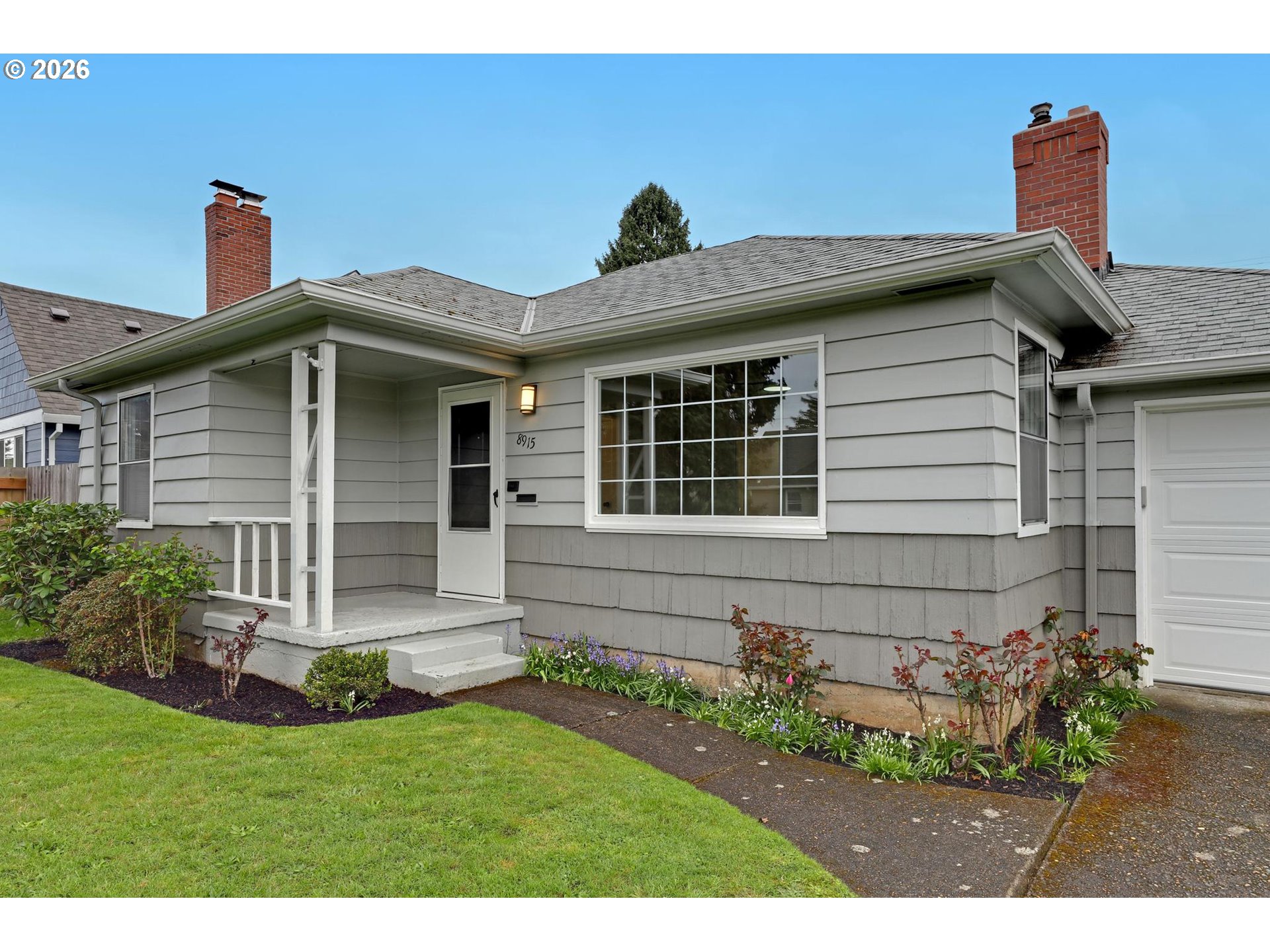 8915 Southeast Market Street Portland, OR 97216 - Photo 1 of 26 a front view of a house with garden