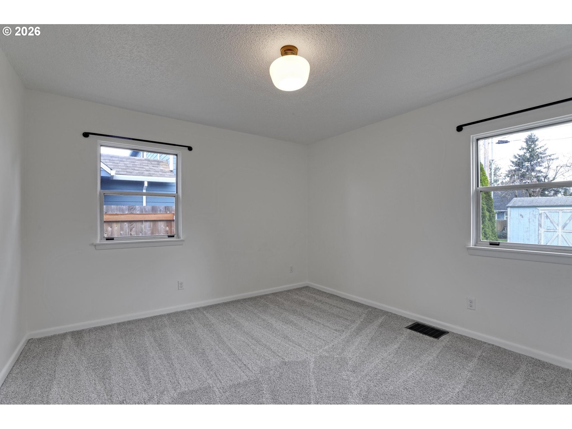 8915 Southeast Market Street Portland, OR 97216 - Photo 13 of 26 a view of an empty room with a window