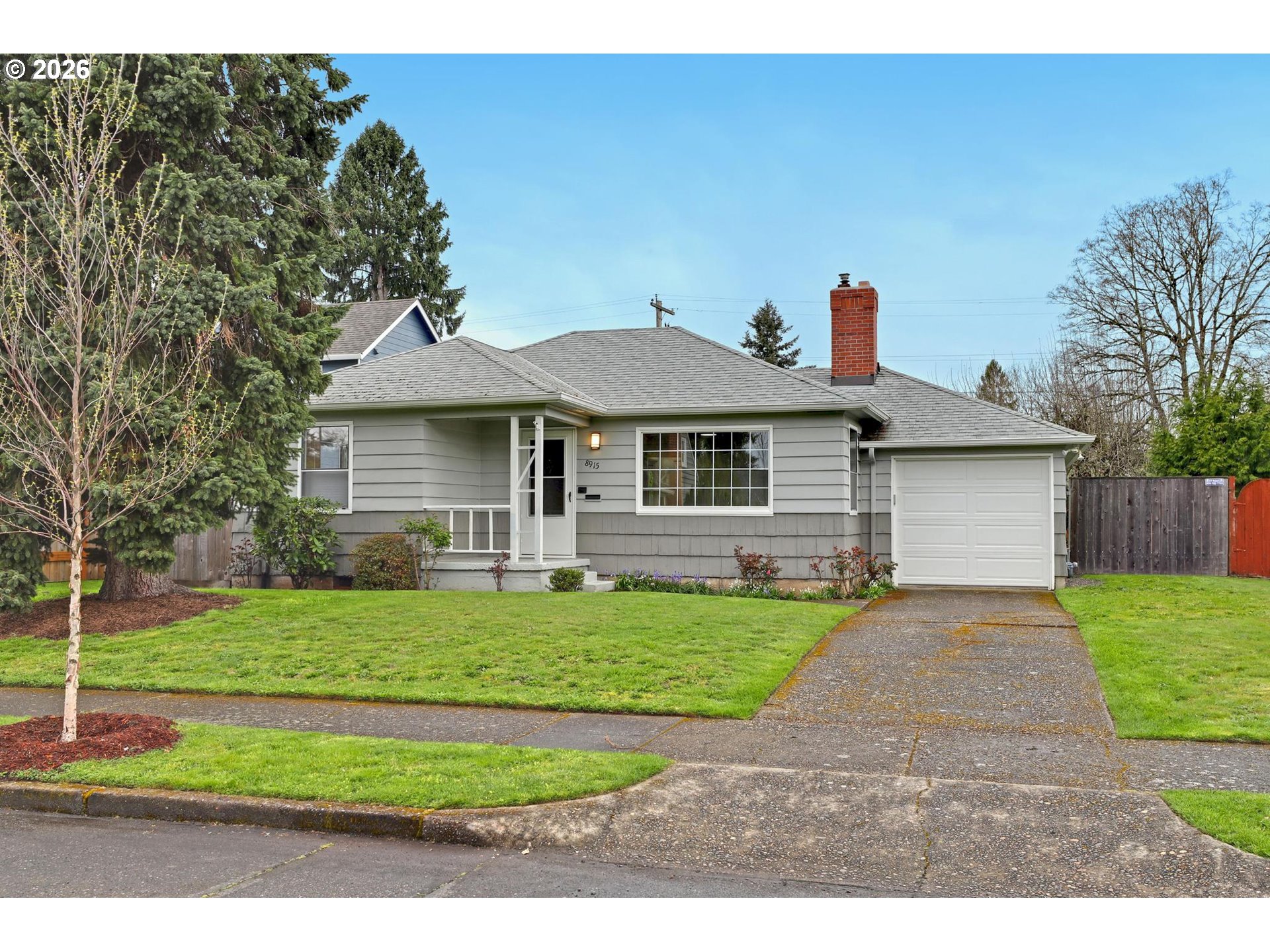 8915 Southeast Market Street Portland, OR 97216 - Photo 2 of 26 a front view of a house with a yard
