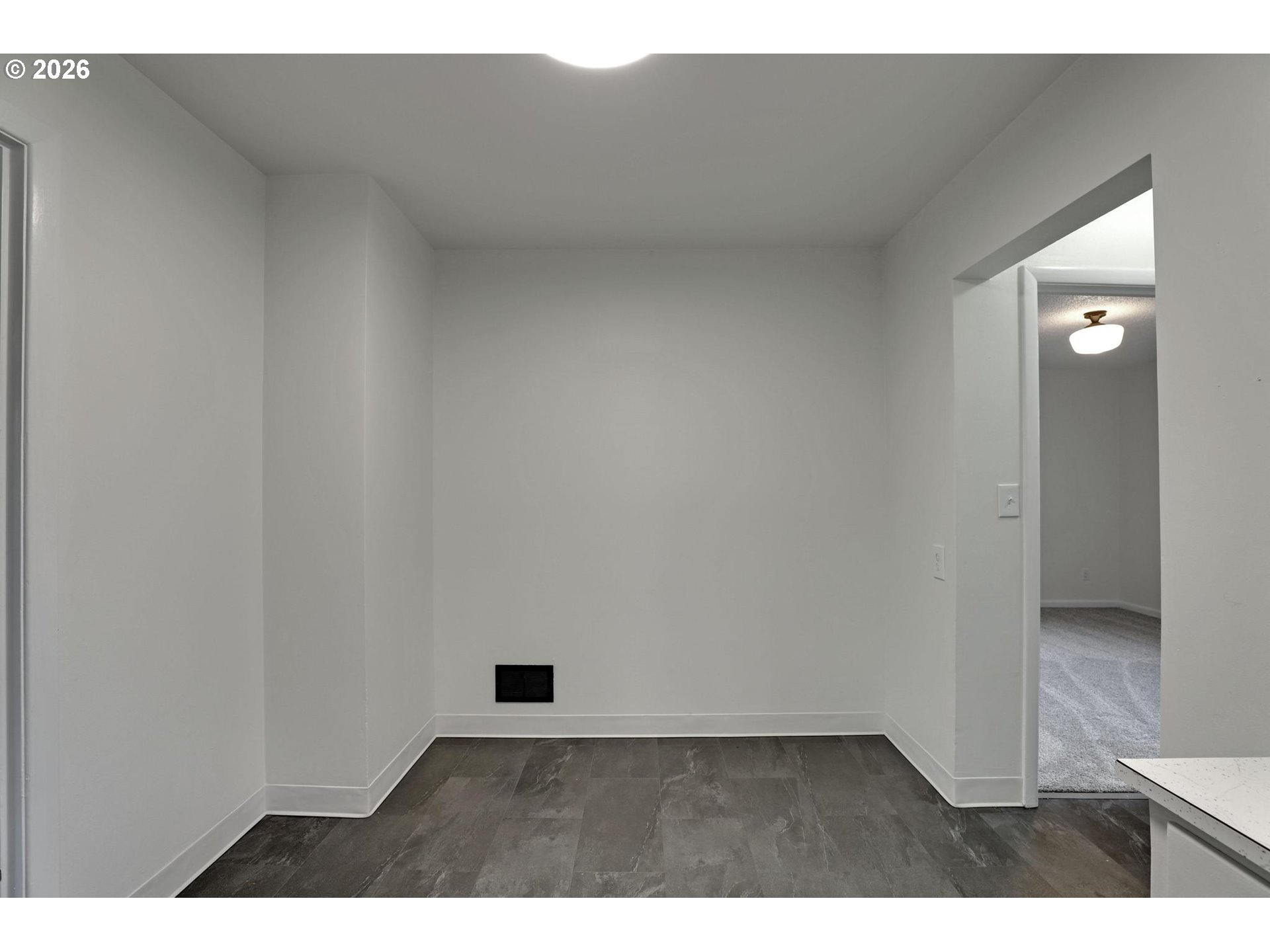 8915 Southeast Market Street Portland, OR 97216 - Photo 8 of 26 a view of an empty room and wooden floor