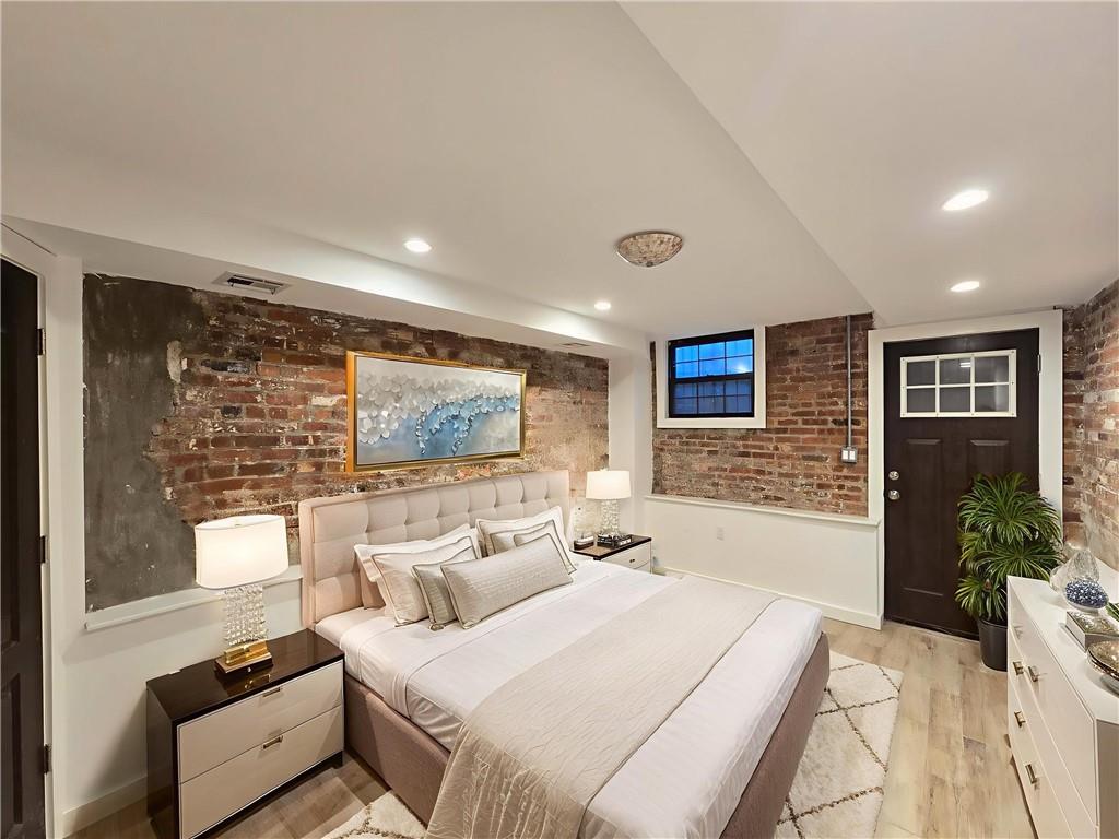 a bedroom with furniture and wooden floor