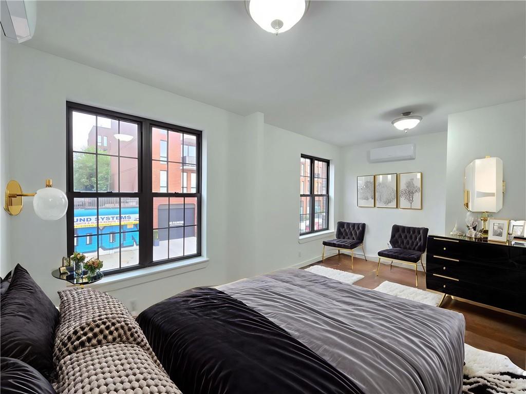 151 Noll Street Brooklyn, NY 11206 - Photo 14 of 30 a bedroom with a bed and a window