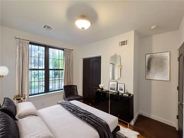 a bedroom with a bed and a window