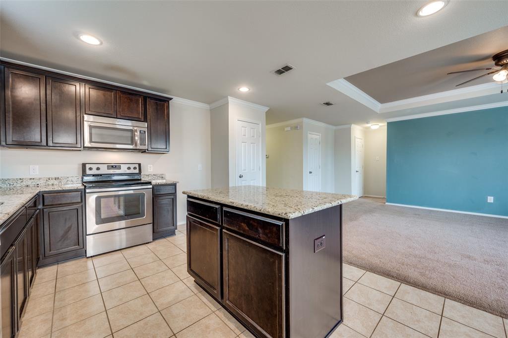 1420 Rivers Creek Lane Little Elm, TX 75068 - Photo 10 of 25 a kitchen with stainless steel appliances granite countertop a stove a sink and a refrigerator