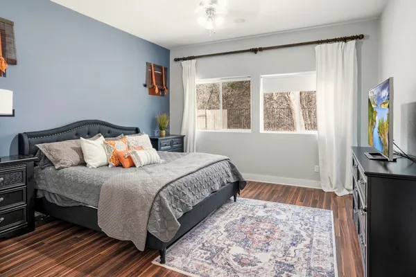 a bedroom with a bed and wooden floor