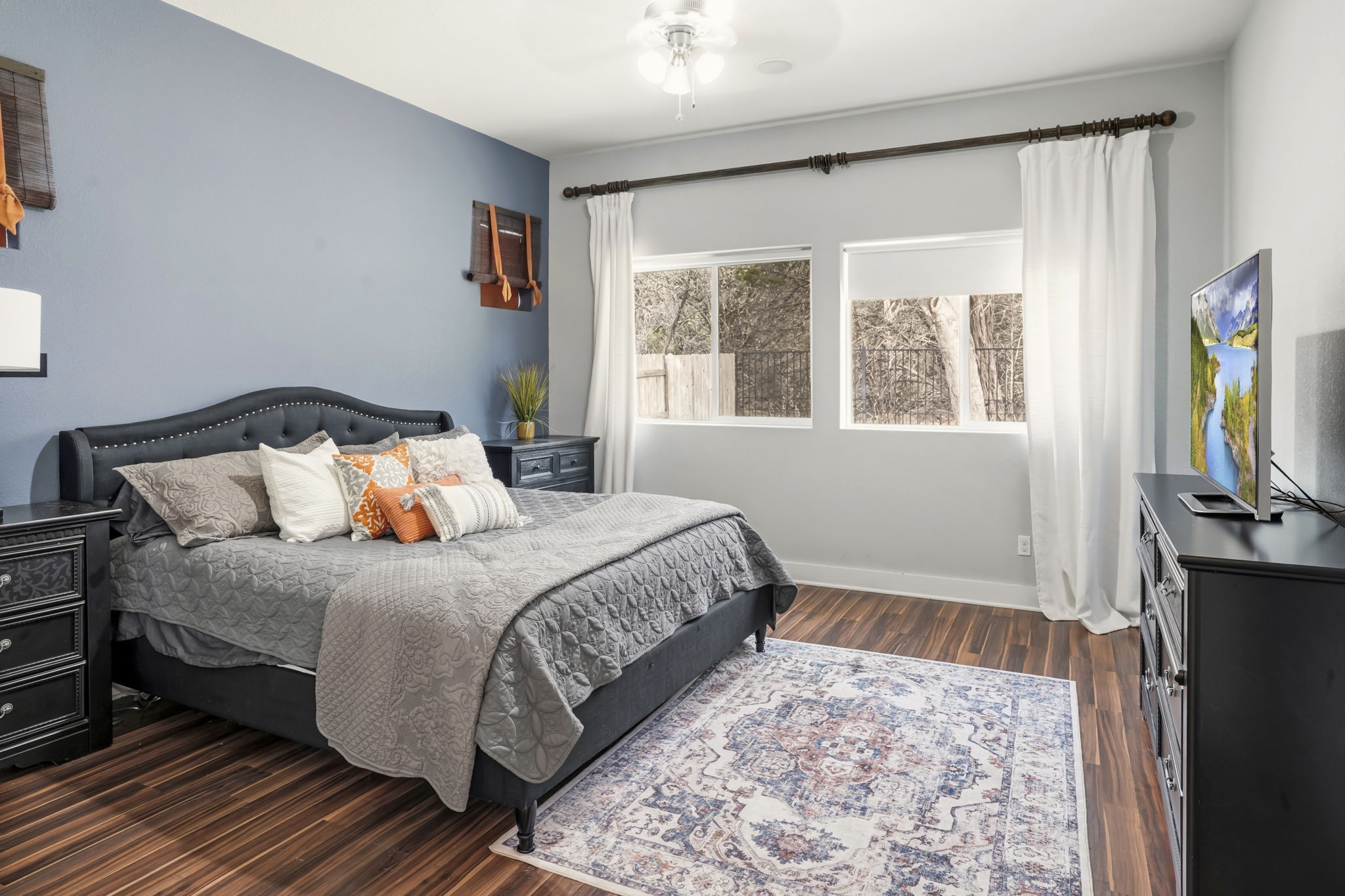 504 Bowery Trail Austin, TX 78753 - Photo 19 of 38 Bedroom featuring a ceiling fan and dark wood-style flooring