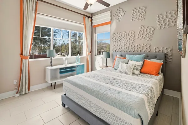 a bedroom with a bed and a large window