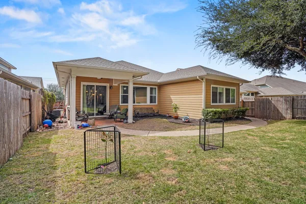 front view of a house with a chairs and table in the patio