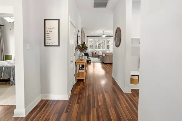a view of a living room with furniture and wooden floor