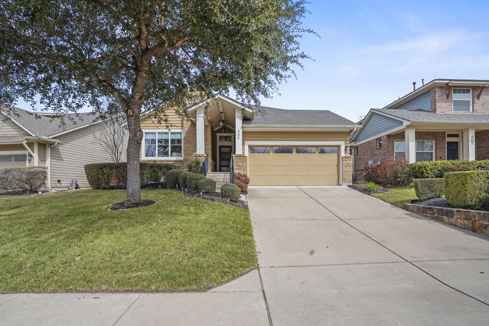 504 Bowery Trail Austin, TX 78753 - Photo 34 of 38 Craftsman house with a garage, concrete driveway, a front yard, and brick siding