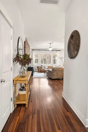 a living room with furniture and a wooden floor