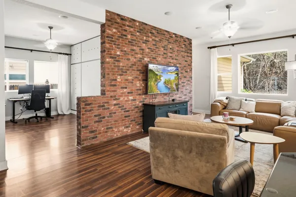 a living room with fireplace furniture and a flat screen tv