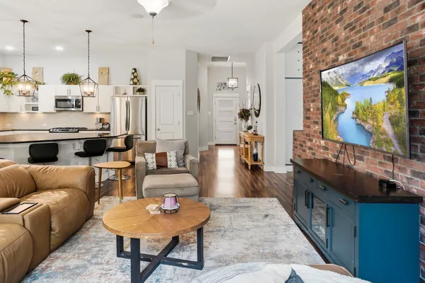a living room with furniture a rug and a flat screen tv