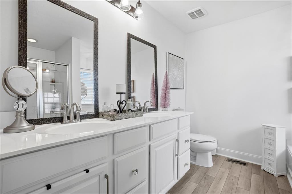 3101 Pointe View Drive Mars, PA 16046 - Photo 22 of 41 a bathroom with double vanity a toilet a mirror and vanity