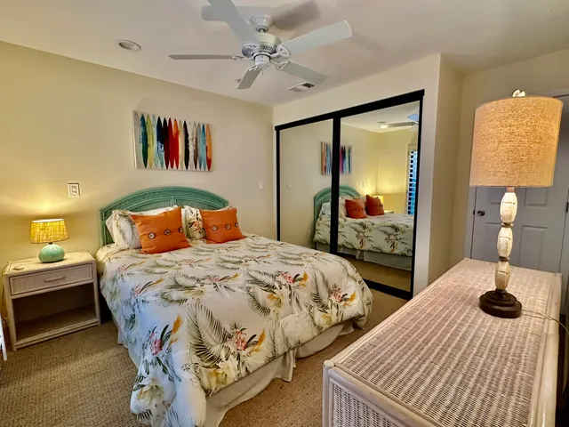 a bedroom with a bed and dresser with mirror