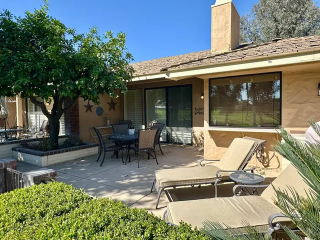 a view of a patio with table and chairs and potted plants