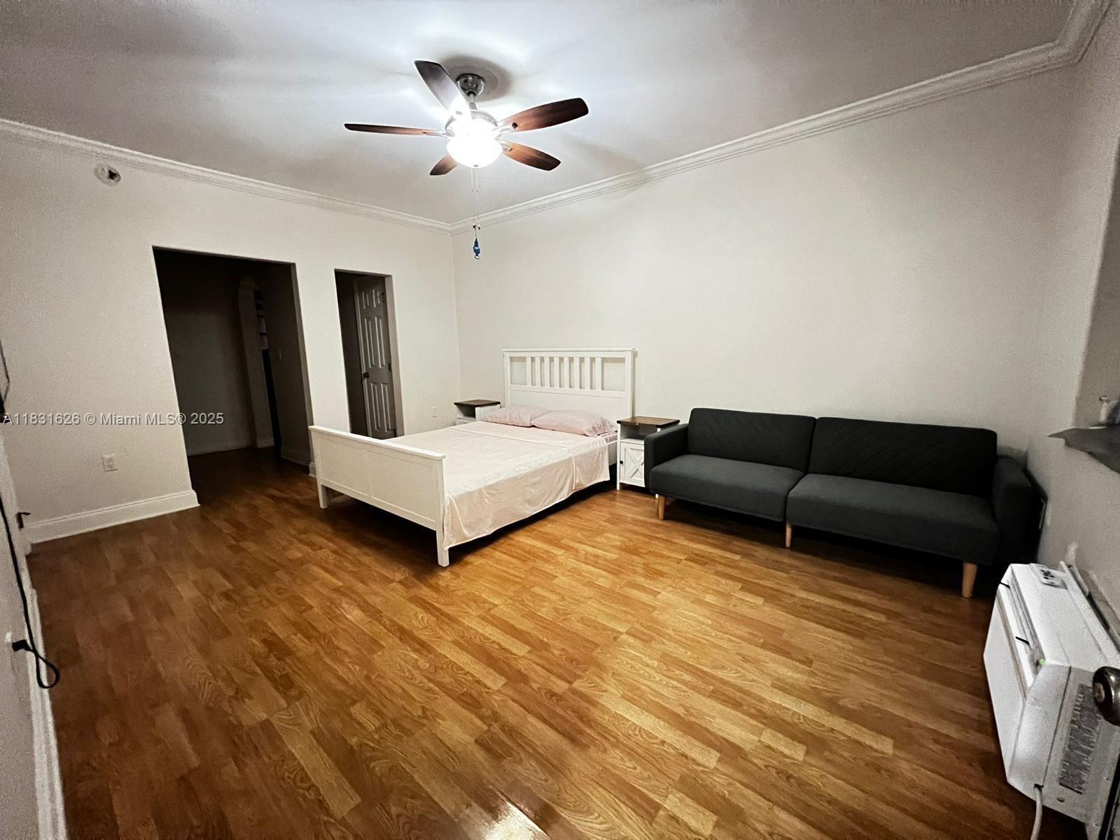 1227 Euclid Avenue, Unit 6 Miami Beach, FL 33139 - Photo 1 of 24 a spacious bedroom with a bed and a ceiling fan