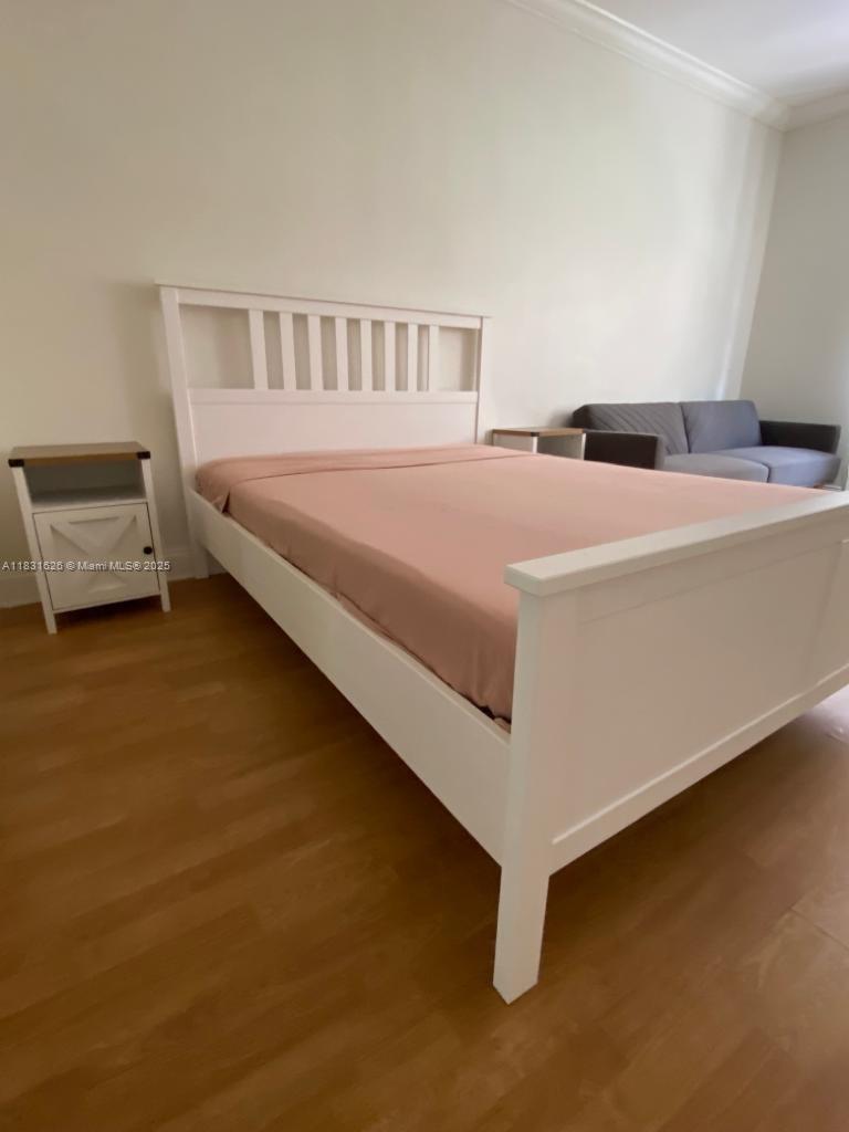 1227 Euclid Avenue, Unit 6 Miami Beach, FL 33139 - Photo 16 of 24 a bedroom with a bed and a night stand