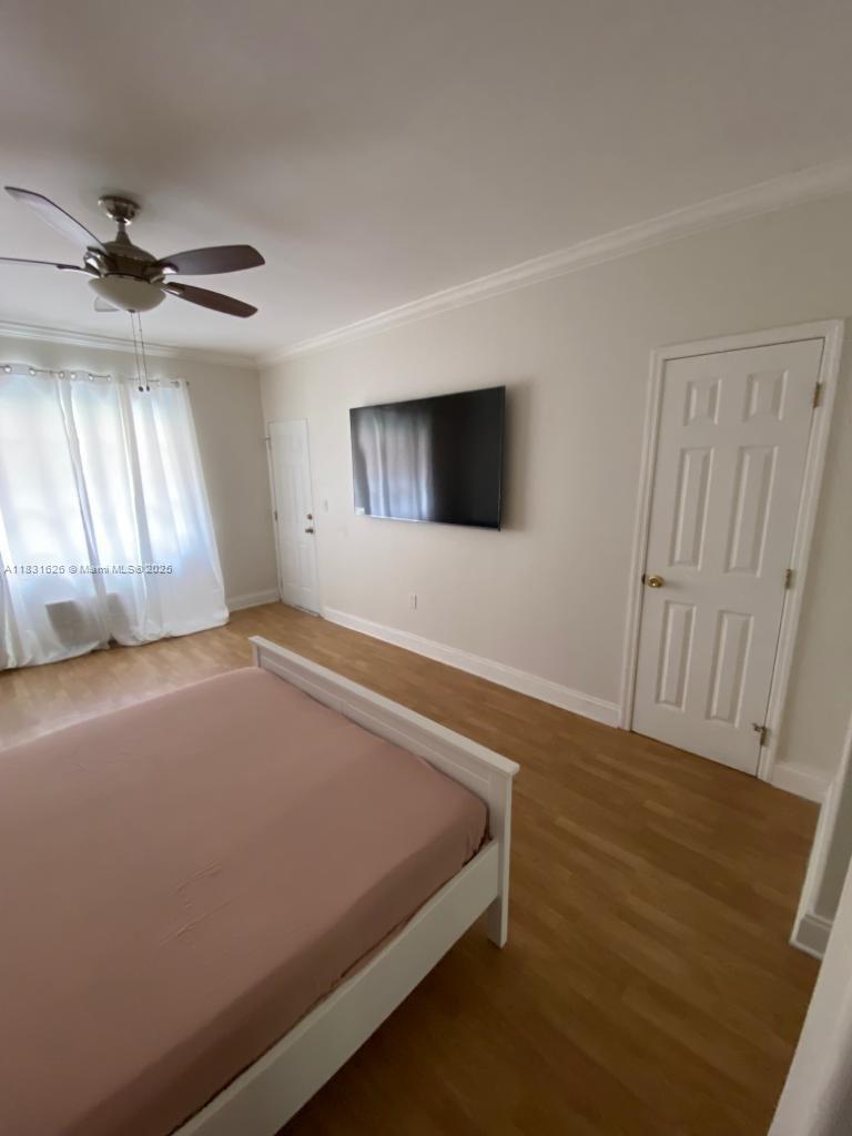1227 Euclid Avenue, Unit 6 Miami Beach, FL 33139 - Photo 20 of 24 an empty room with windows and flat screen tv