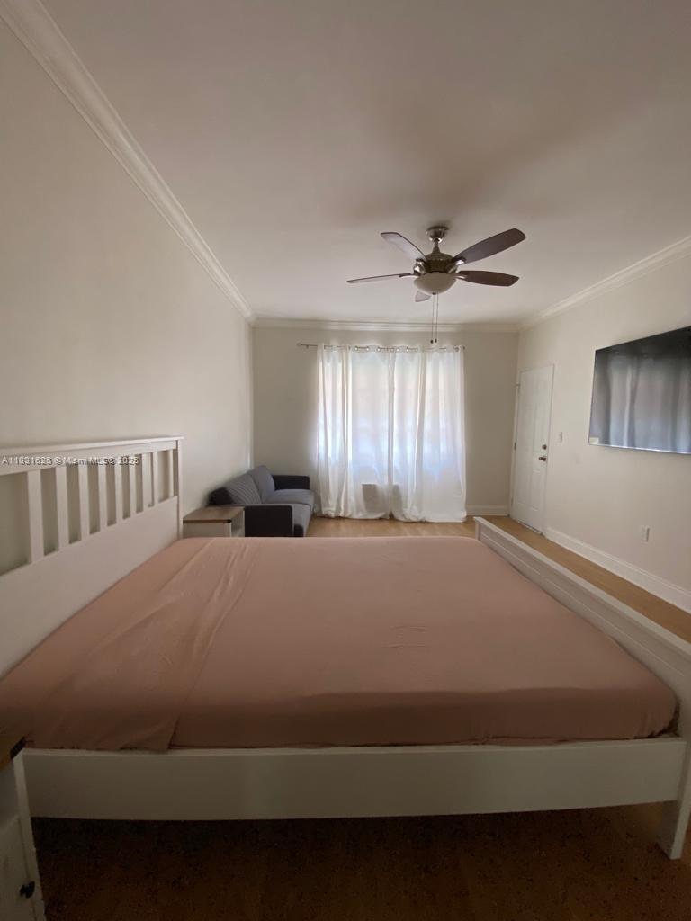 1227 Euclid Avenue, Unit 6 Miami Beach, FL 33139 - Photo 2 of 24 a bedroom with a bed and window